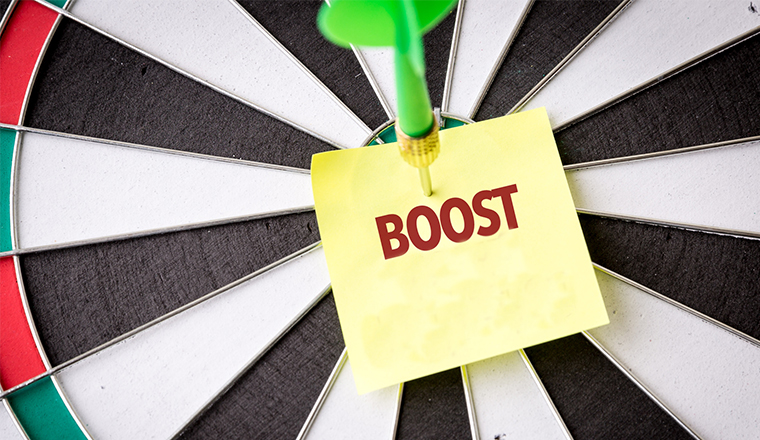 A dartboard with the words boost in the centre
