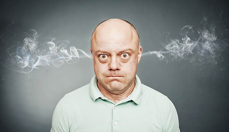 An angry person with steam coming out of their ears