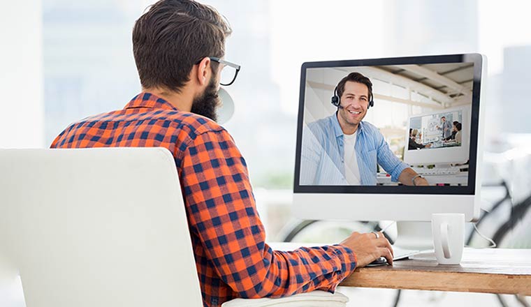 A man has a video call with his colleague.