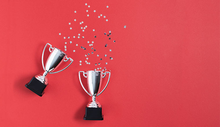 A picture of two trophies with glitter