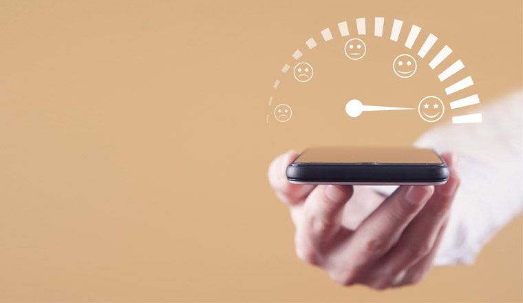 A hand holding a phone with a satisfaction meter above
