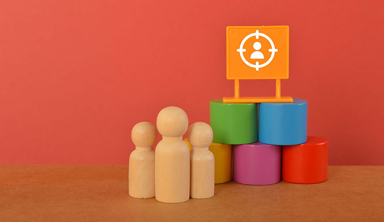 Wooden people with blocks and person in target icon - staffing concept
