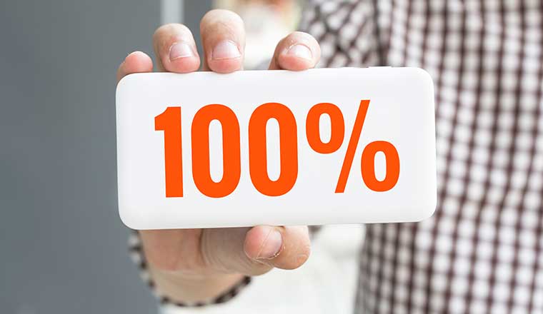 A hand showing 100% on the back of a phone