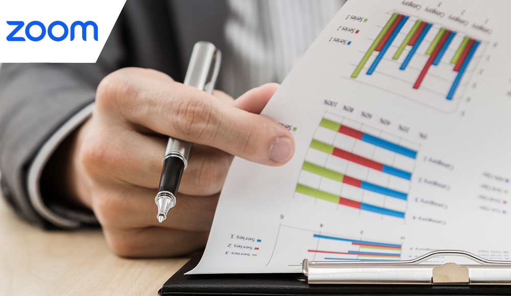 Businessman's hand showing financial report on table