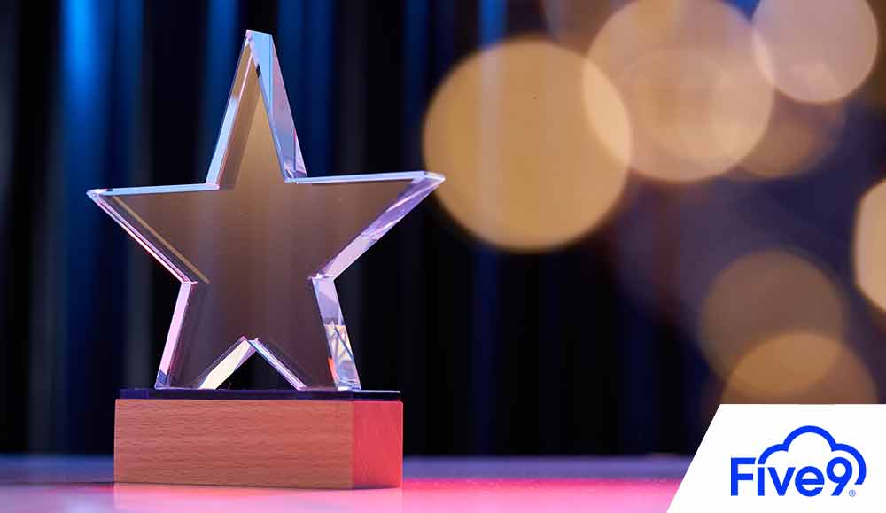 Star shape trophy with color light against stage curtain