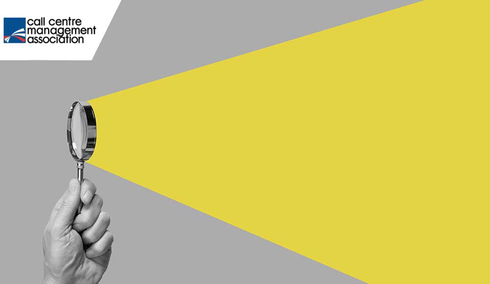 A hand with magnifying glass with yellow ray - research concept