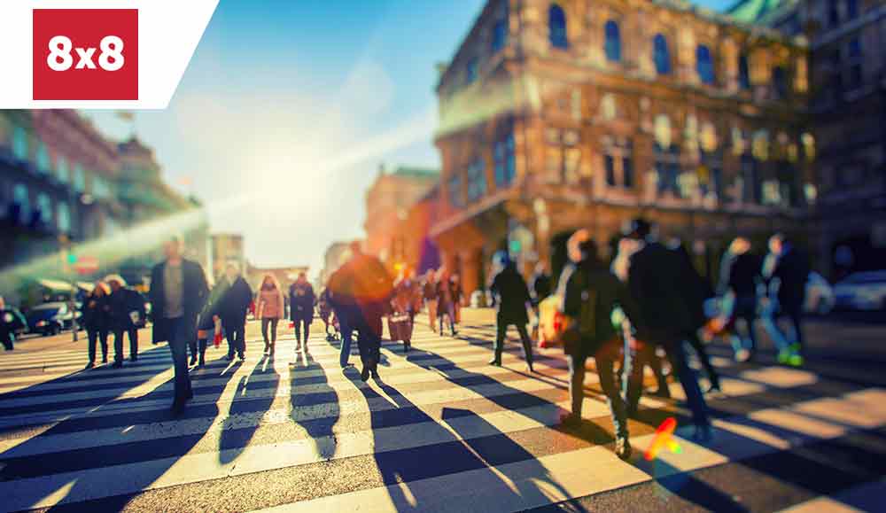 crowd of people walking on sunny streets