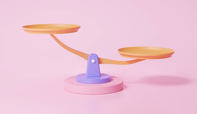 Weighing scales on pink background - balance concept