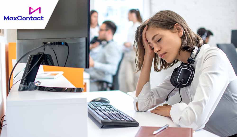 call centre agent with headset over neck looking upset