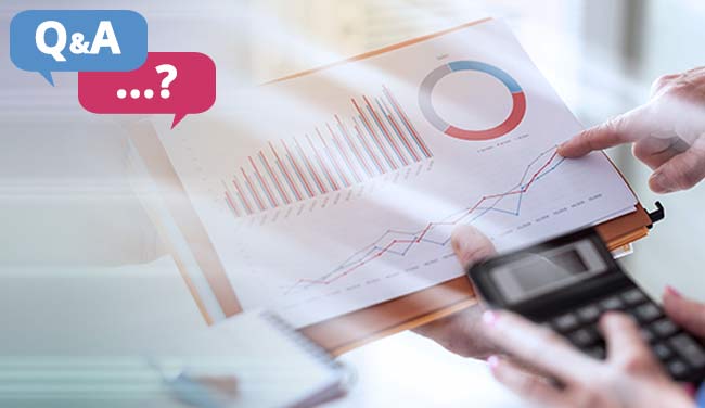 Person holding calculator looking at graphs