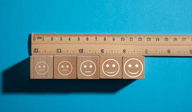 Ruler measuring blocks with happy faces.