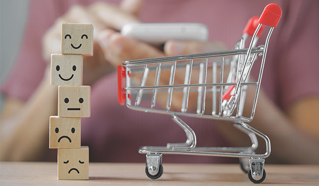 Mini shopping trolly with a stack of 5 blocks all with different emotions of faces on them