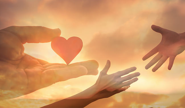 2 helping hands with a heart