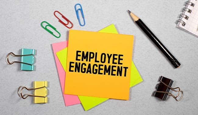 The words 'Employee Engagement' on a post it note with stationary around it