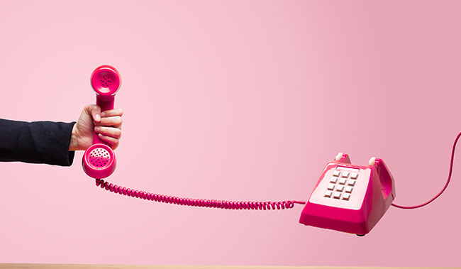 Old telephone being held by a hand