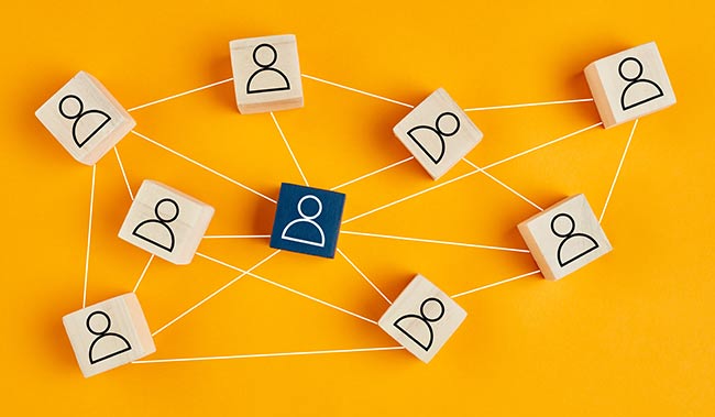 Wooden blocks with people icon on yellow background