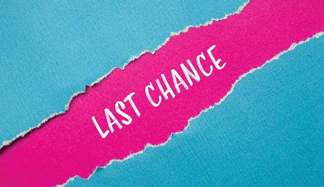 Last chance words written on ripped blue paper with pink background.