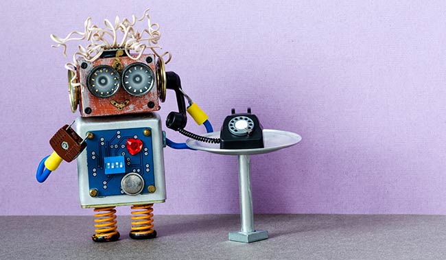 Mini robot holding a old phone