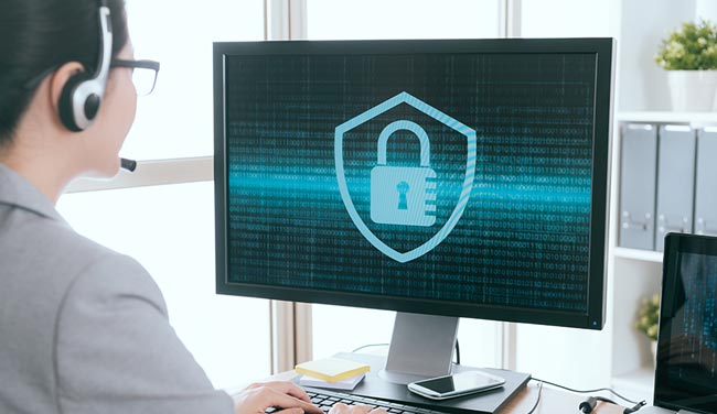 Call centre employee looking at computer with padlock