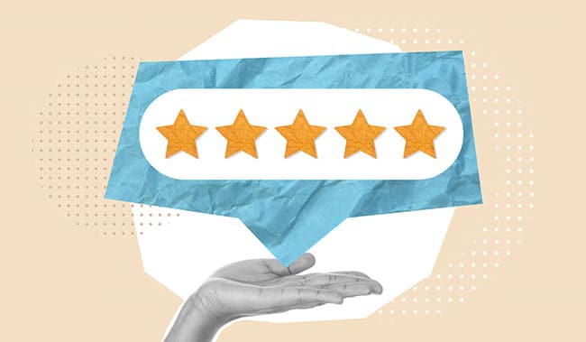 Hand holding a speech bubble with 5 stars in it