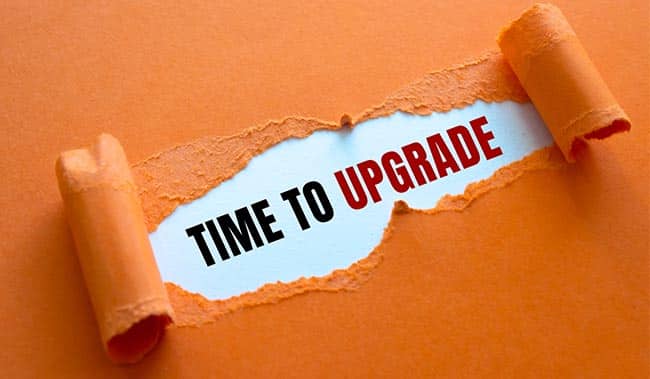 Orange paper that has been ripped and says 'Time to Upgrade' behind it