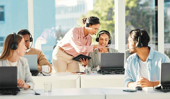 Contact Centre Agents working on their laptops