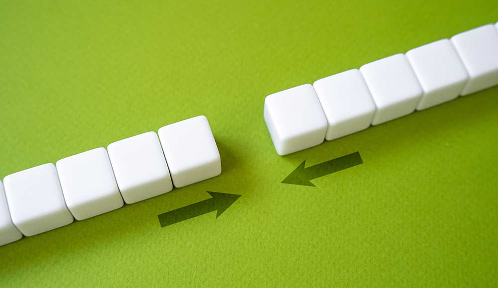 Close gap concept with two sets of blocks being brought together