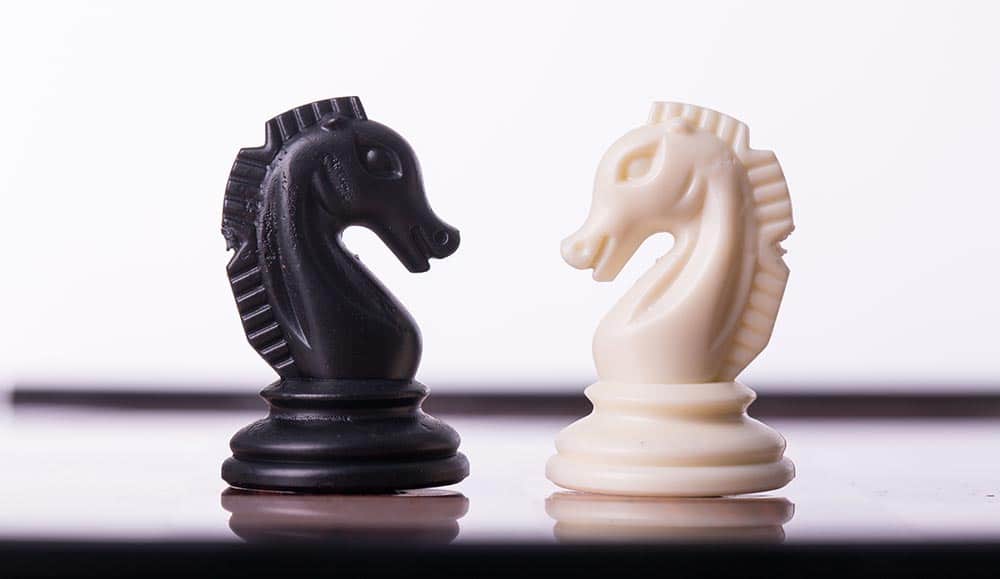 Two chess pieces facing each other - compare strategy concept