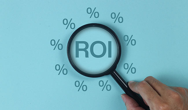 Magnifying glass with the word ROI in the centre and percentage symbols around it - on a blue background