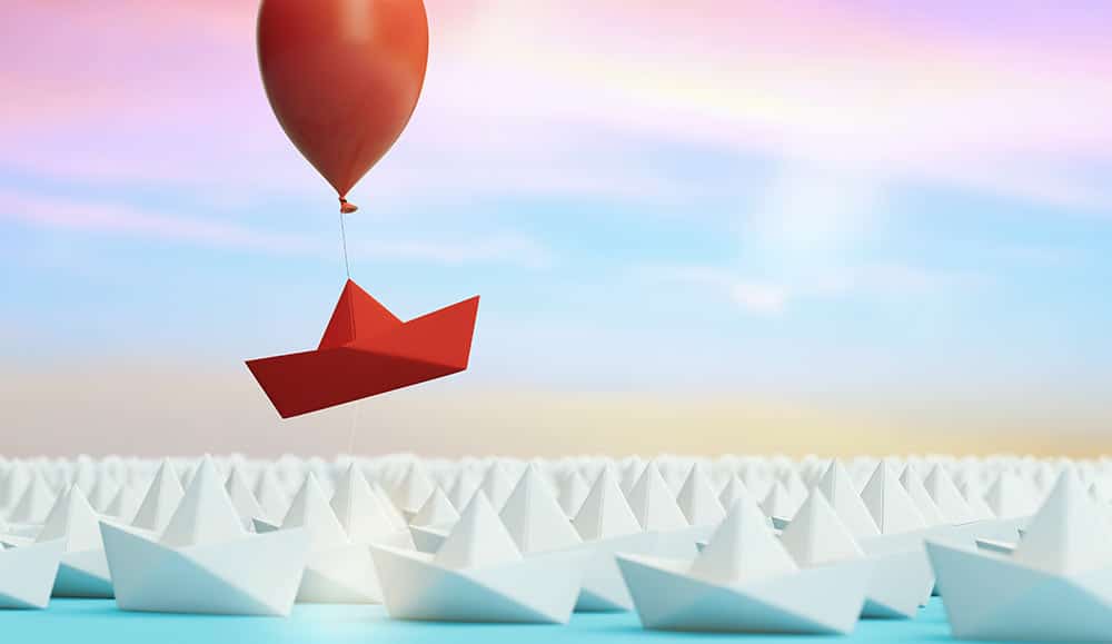 Red boat rising out of a crowd - differentiator concept