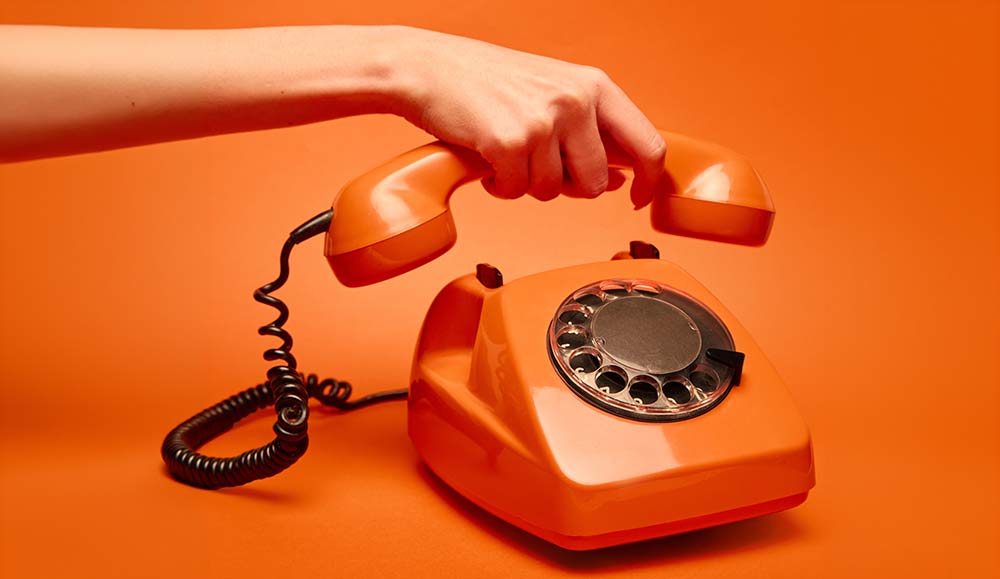 Person picking up a telephone
