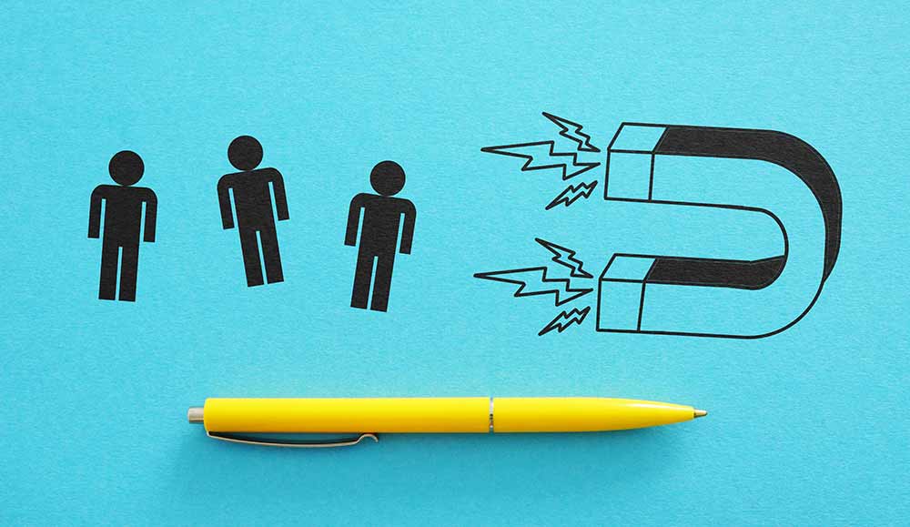 Retnetion concept with people shapes and a magnet drawn on a blue background