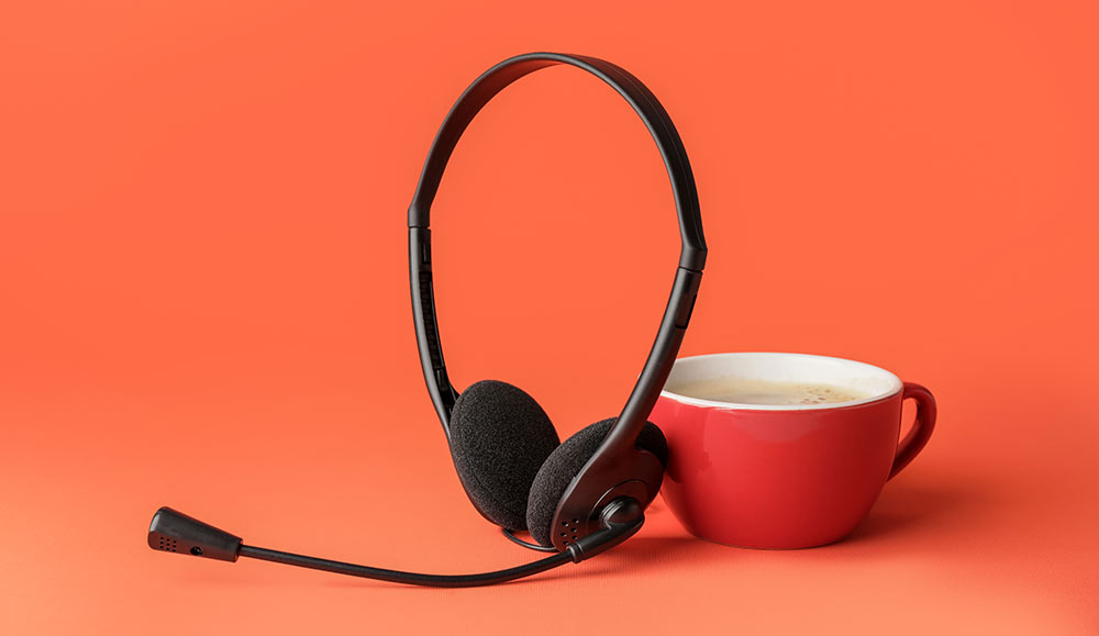 Headset with cup of coffee - voice channel care concept