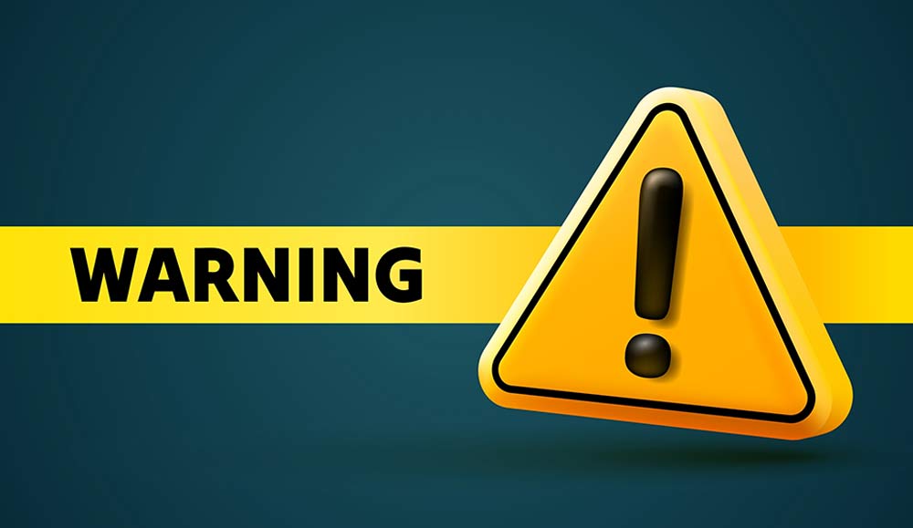 A warning sign with exclamation mark and WARNING text on yellow banner