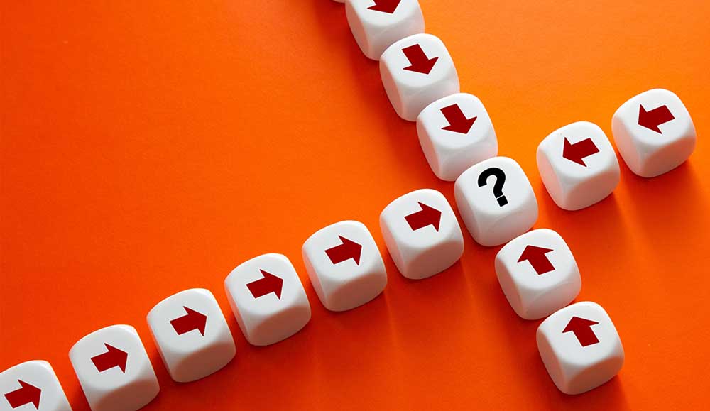 White cubes forming diverging arrows centered on a question mark